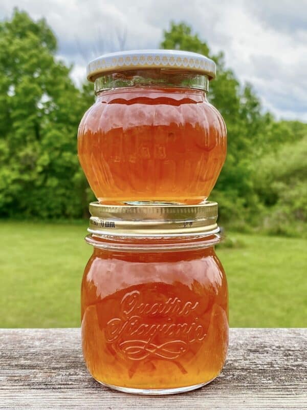 2 jars of kumquat marmalade stacked on each other
