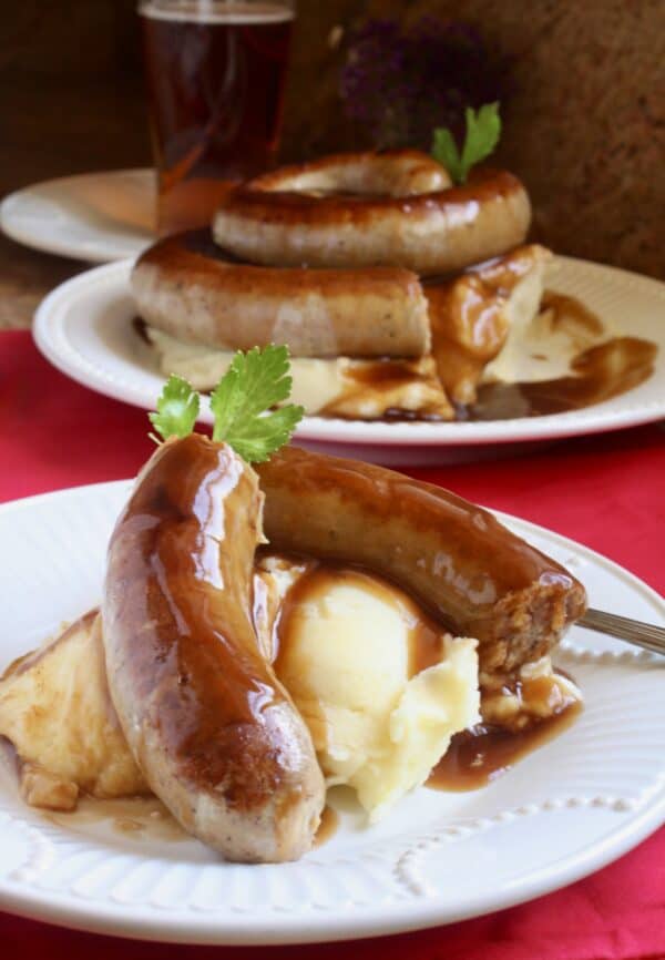 serving cumberland sausages with mash and gravy