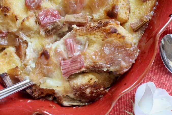 Spooning rhubarb bread pudding into serving dishes.