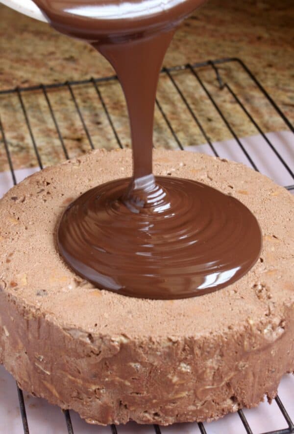 pouring chocolate over biscuit cake