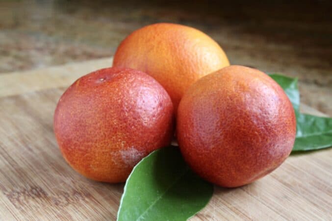 3 blood oranges with leaves