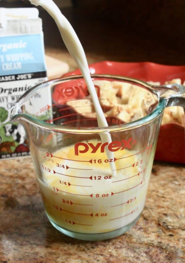 pouring milk into eggs in jug