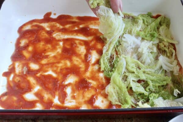 laying cabbage into pan