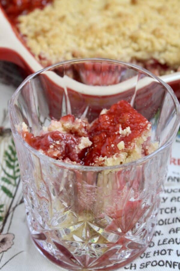 strawberry rhubarb crumble in a crystal glass