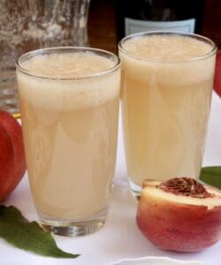 two Bellini drinks with white peaches