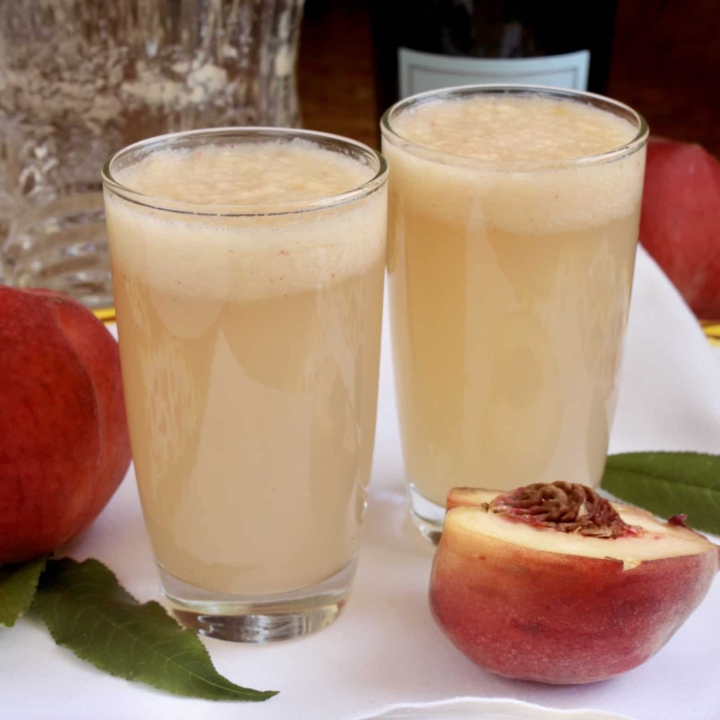 two Bellini drinks with white peaches