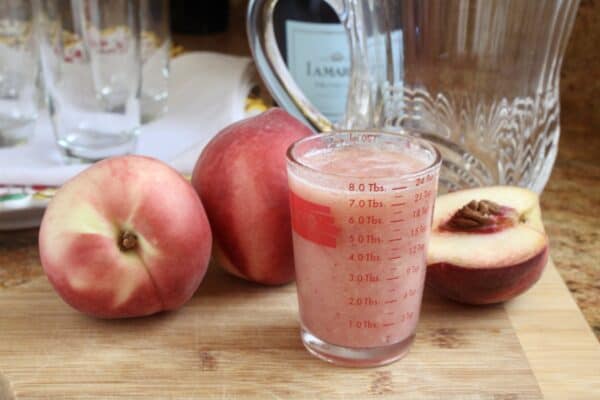 measuring peach puree for Bellini drinks