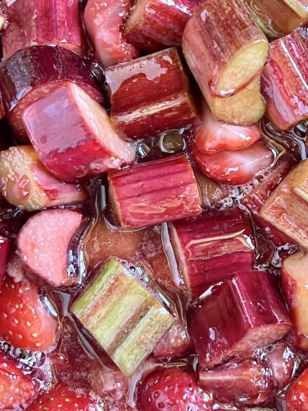 putting strawberries and rhubarb in a pot