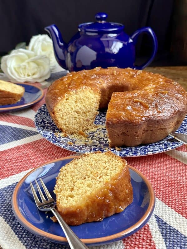 Slice of marmalade cake with bundt and teapot in back