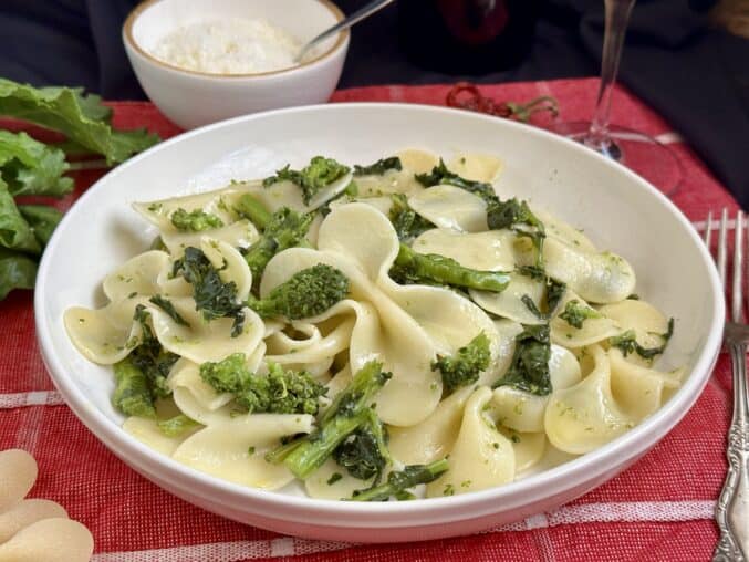 rapini pasta with bowl of cheese