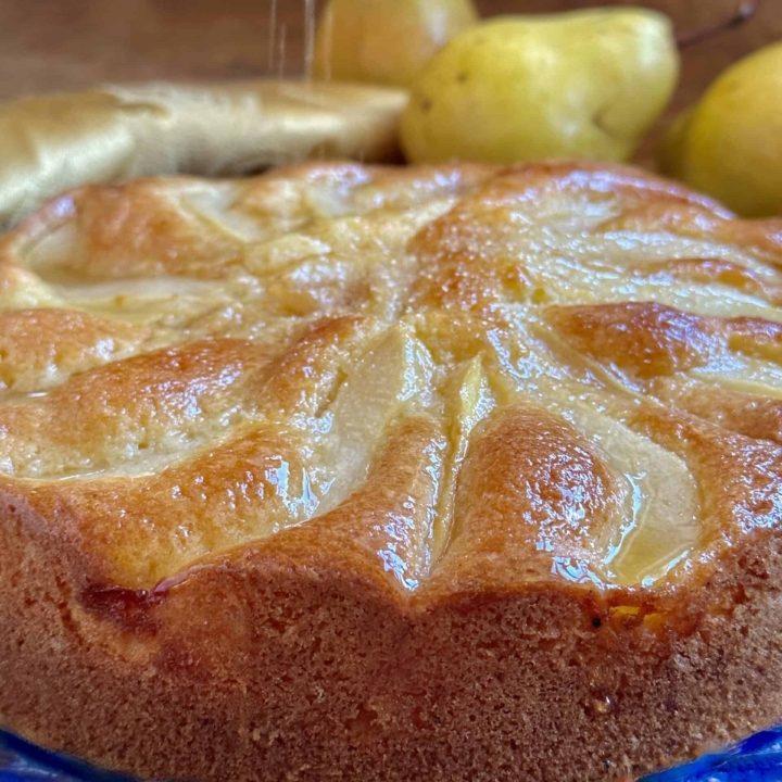 Honey pear cake getting sprinkled with sugar