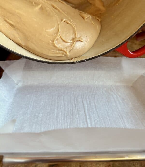 Pouring tablet mixture into pan.