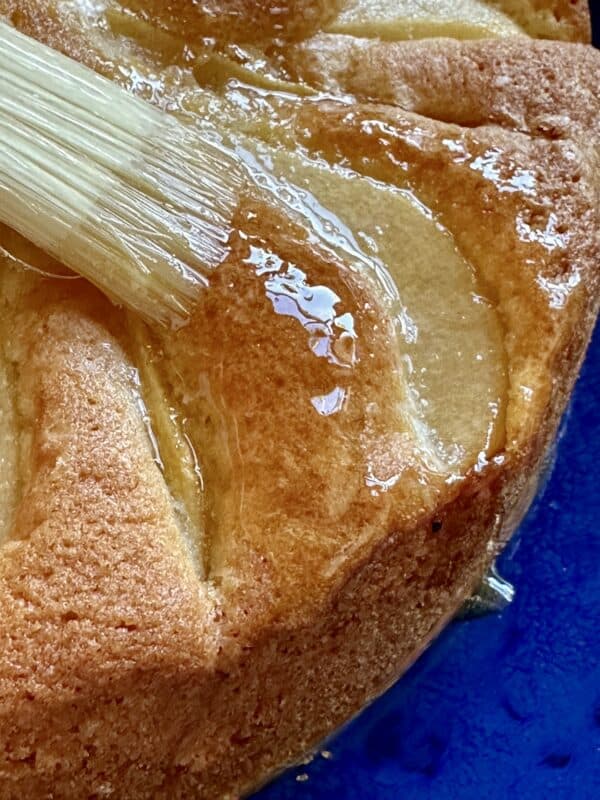 brushing honey on the pear cake