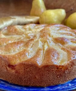 Honey pear cake getting sprinkled with sugar