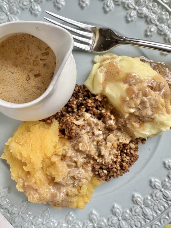 haggis, neeps and tatties on a plate with sauce