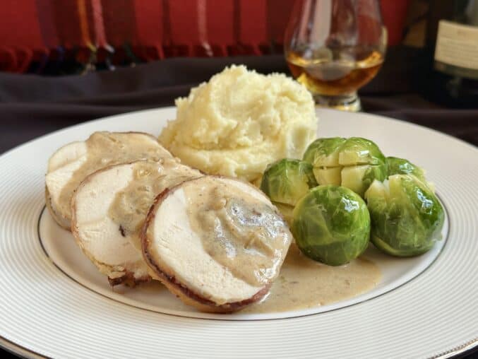 chicken Braemar on a plate with tartan background and whisky