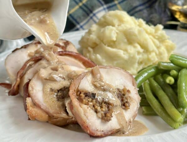 pouring whisky sauce on chicken