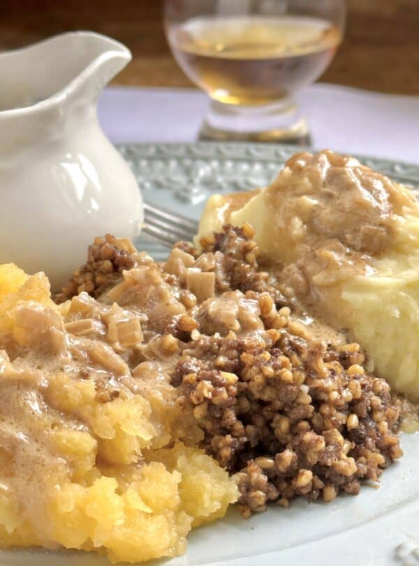 haggis, neeps and tatties with jug of whisky sauce and a wee dram