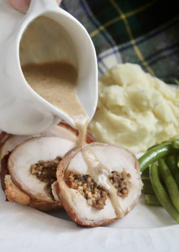 Pouring whisky sauce over sliced Balmoral chicken