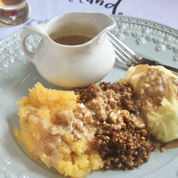 haggis, neeps and tatties with jug of whisky sauce and a wee dram