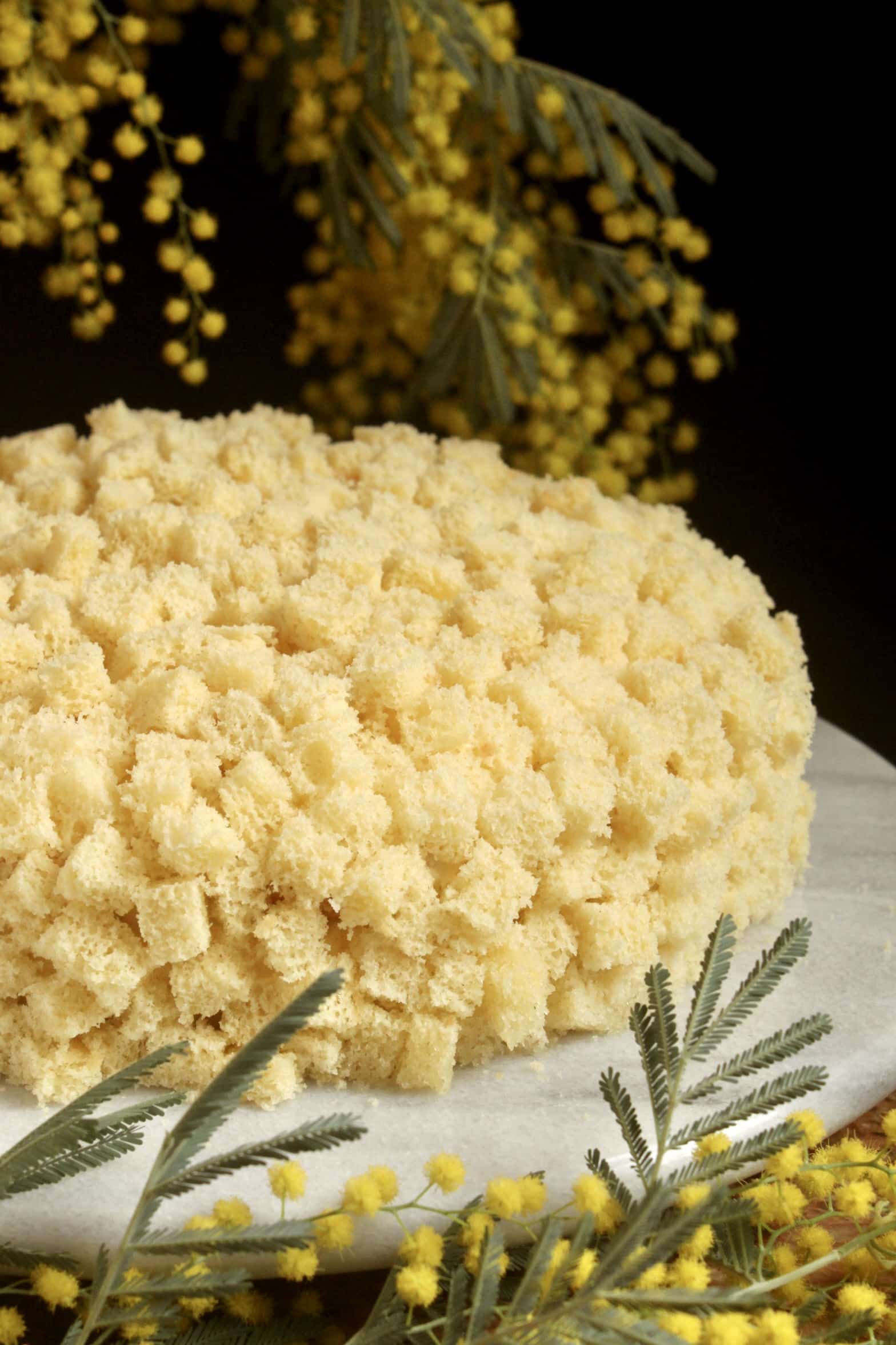 slice of International Women's Day cake with mimosa flowers