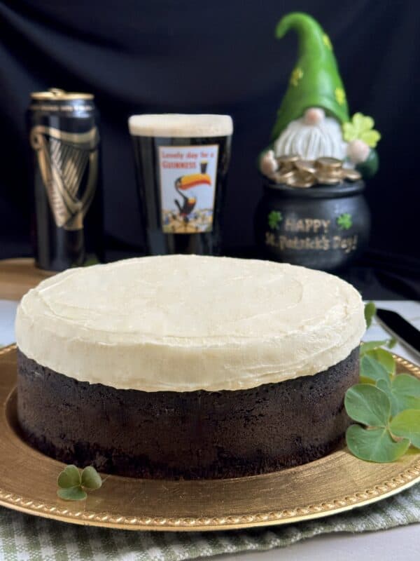 Guinness chocolate cake with can, glass of beer and leprechaun