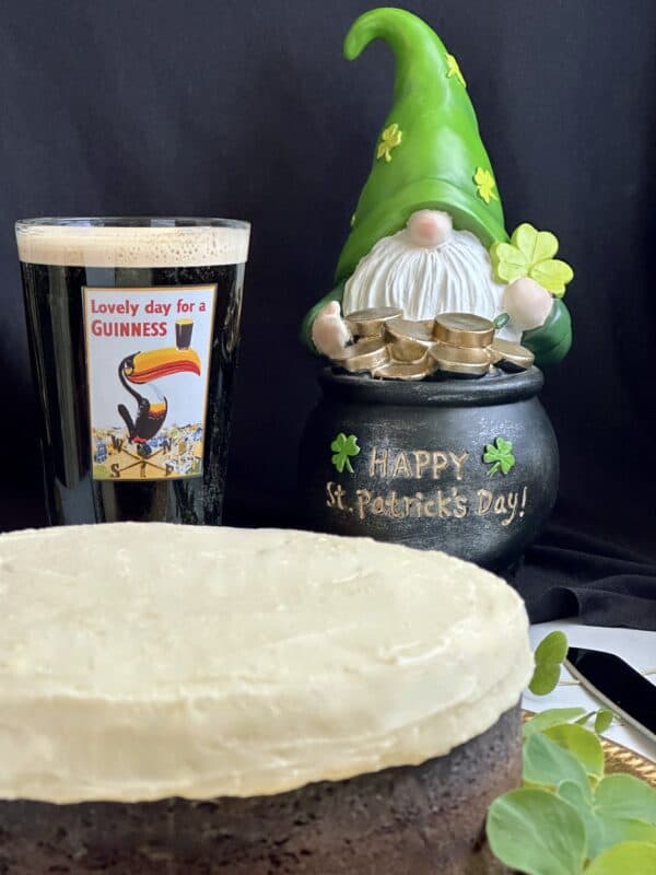 Guinness chocolate cake with glass of Guinness and leprechaun