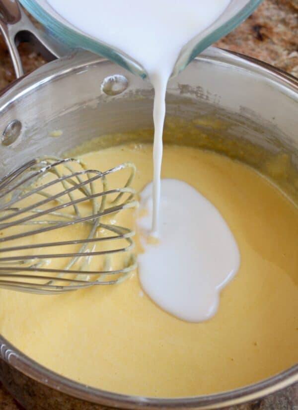 adding milk to pastry cream