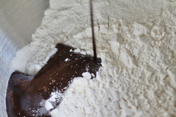 pouring the chocolate mixture into the flour