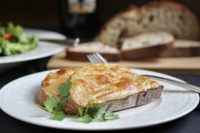 Welsh rarebit with bread in background