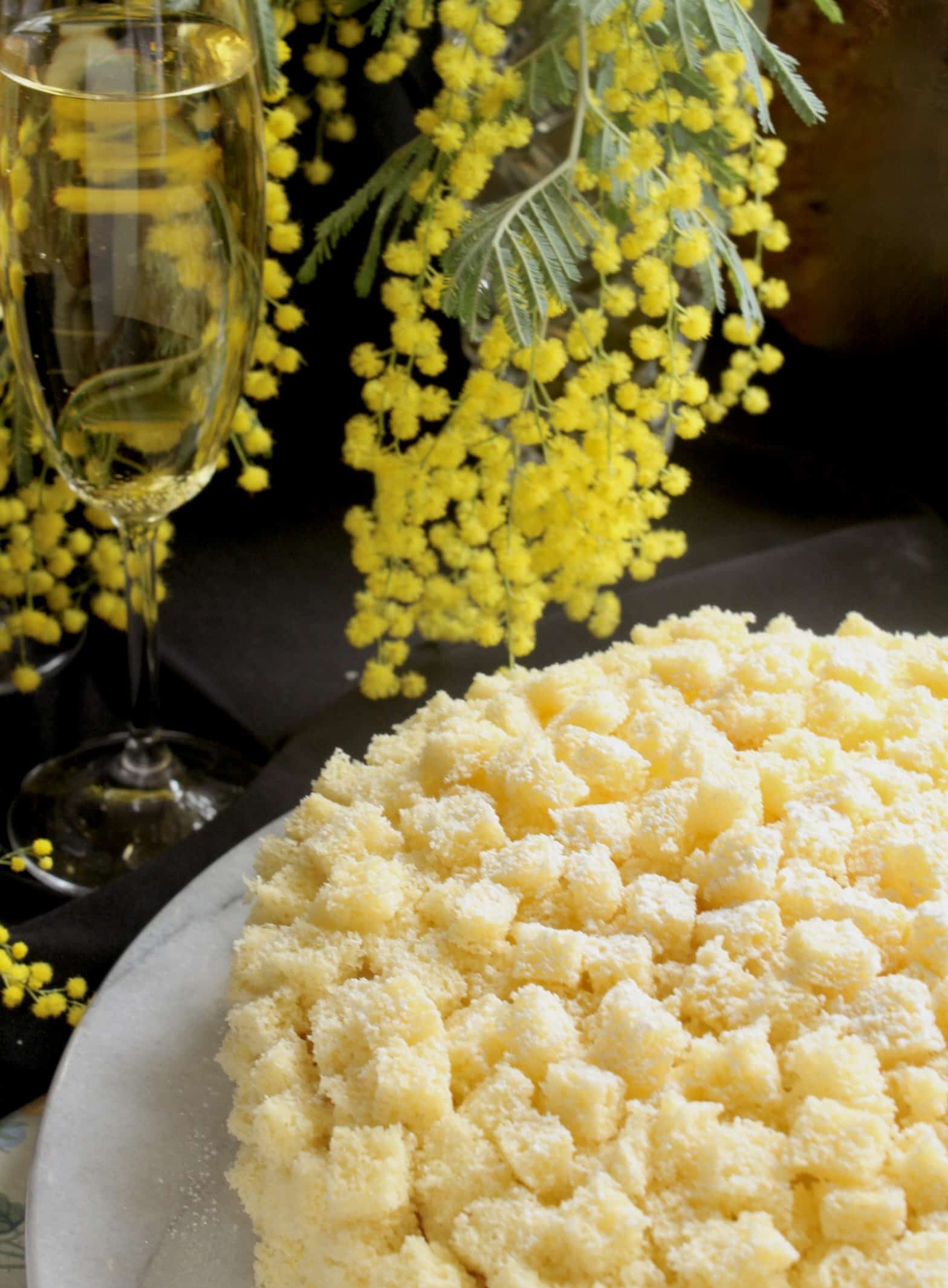 slice of international Women's Day cake with mimosa and glasses