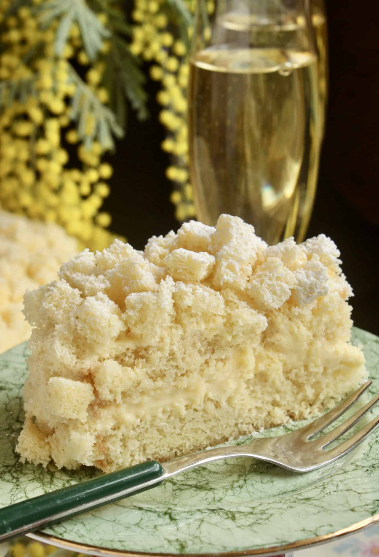 slice of International Women's Day cake with mimosa and glasses