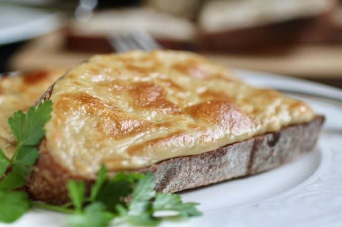 close up Welsh rarebit on a plate with parsley