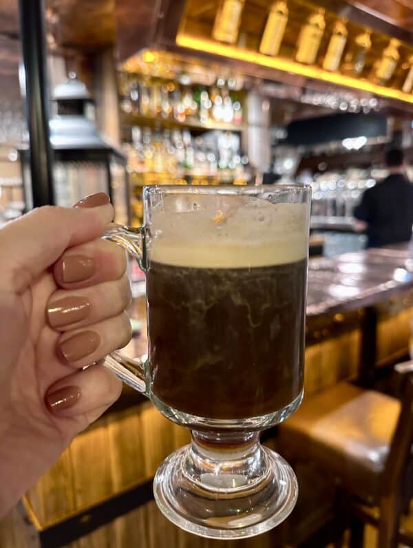 holding an Irish coffee in a Dublin bar