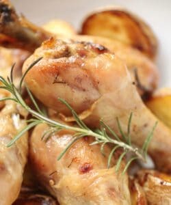 close up of drumsticks and sprig of rosemary
