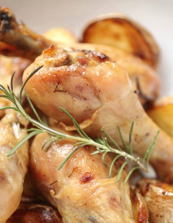 close up of drumsticks and sprig of rosemary