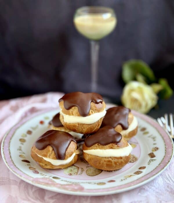 chocolate topped profiteroles with a liqueur glass 
