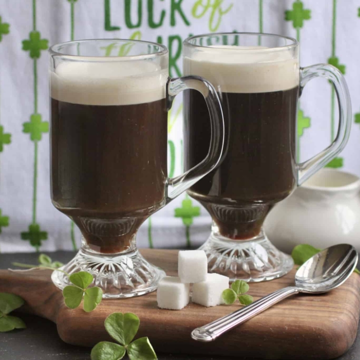 Irish coffees with sugar cubes on a board