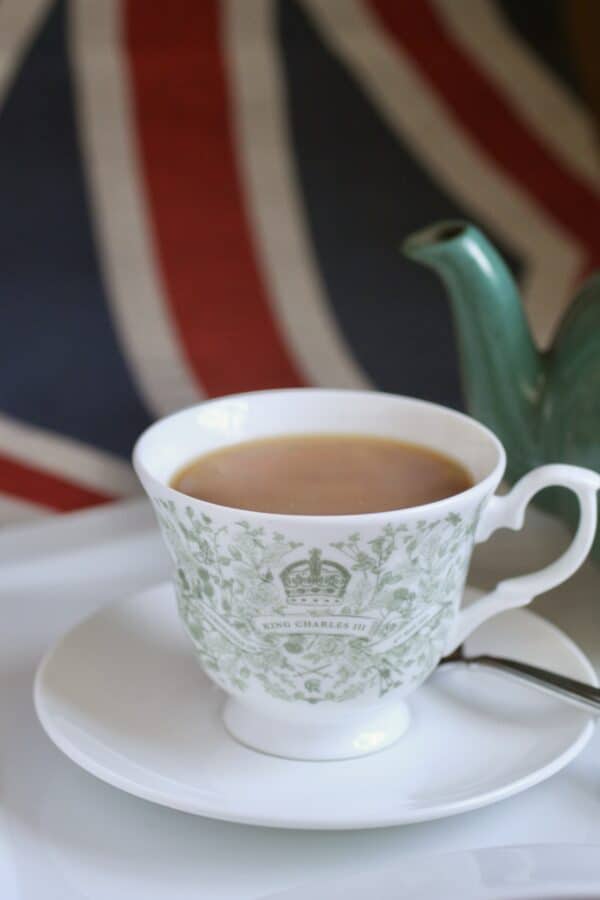 cup of tea in a coronation cup and union jack in the background