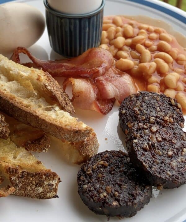 black pudding, eggs, bacon, beans and toast soldiers