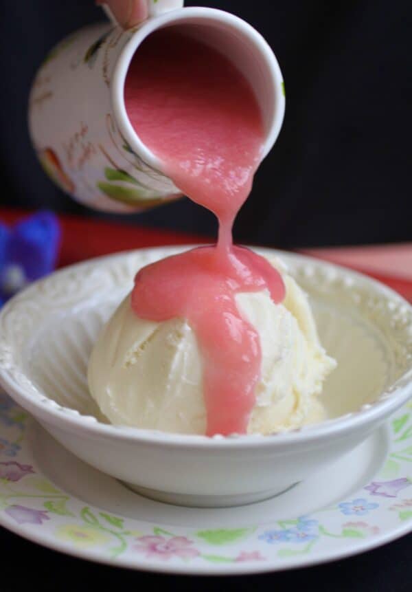 pouring rhubarb sauce over ice cream