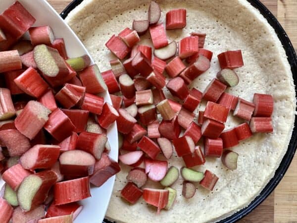 adding rhubarb to the tart shell