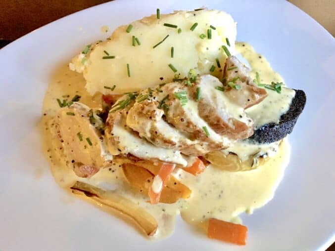 roast pork with baked apple, black pudding and mashed potatoes with a cream sauce