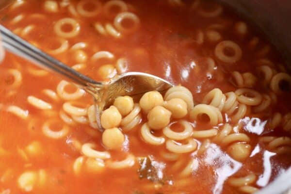 stirring sauce into pasta