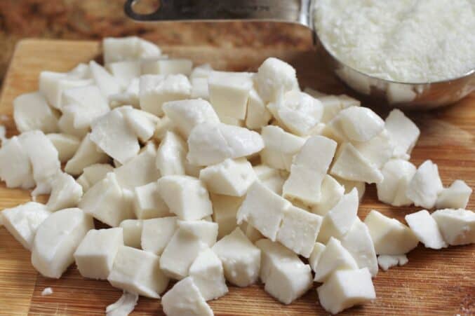 mozzarella cubes on cutting board