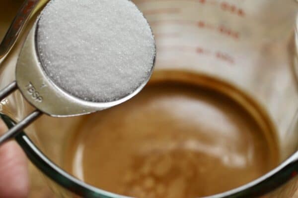 adding sugar to coffee