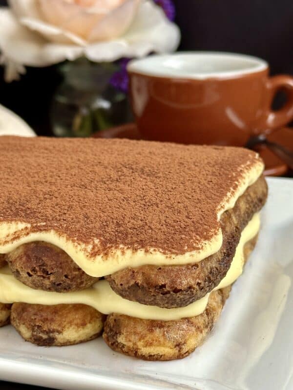 original recipe tiramisu on a plate with cup in background