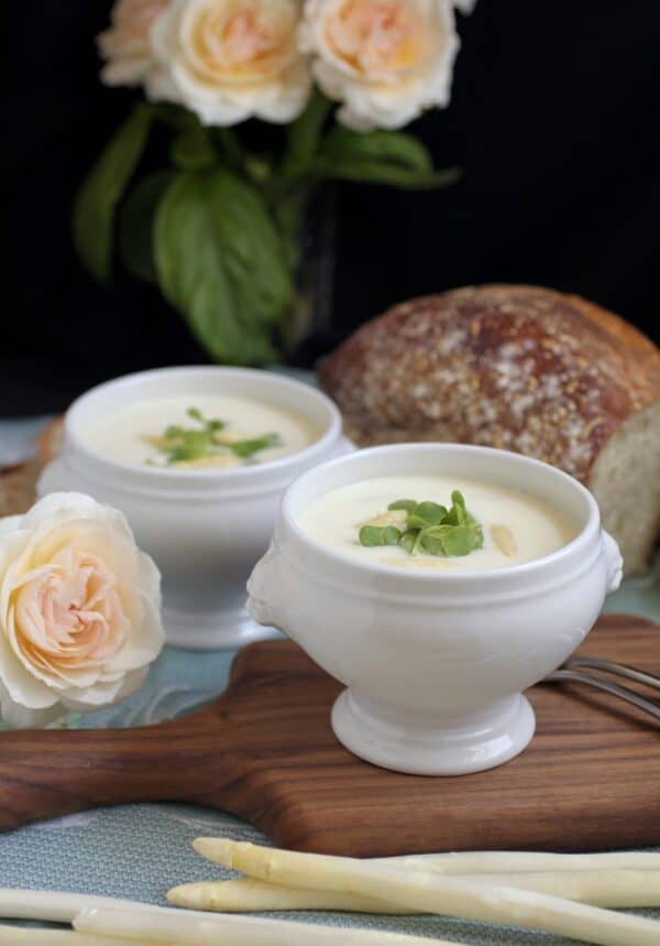 asparagus soup in lion head bowls with bread and roses