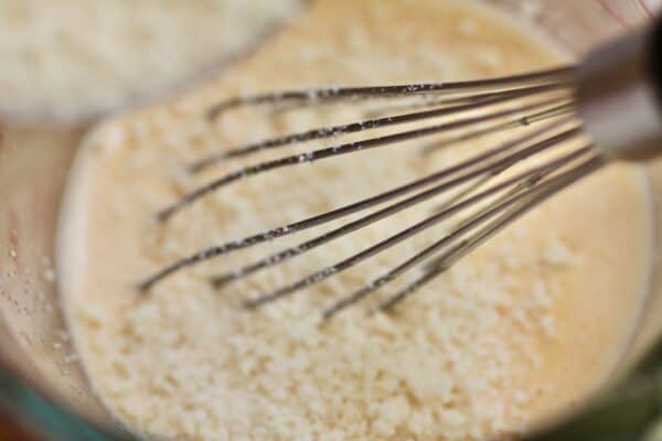 adding grated pecorino romano to egg cream pasta sauce