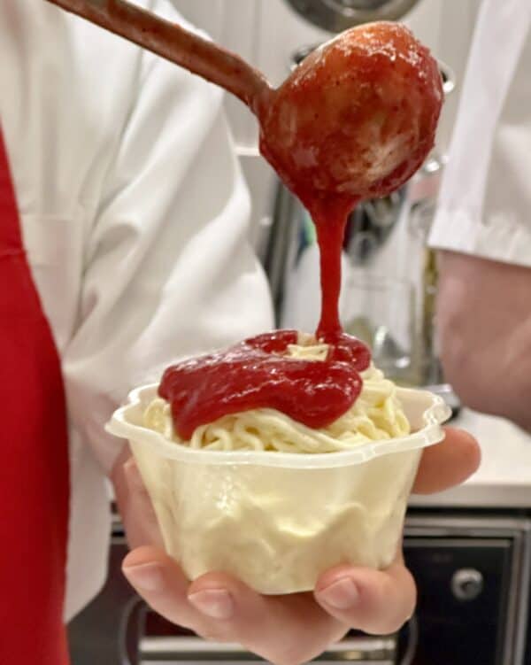 pouring on strawberry sauce